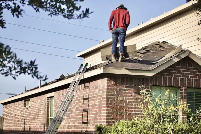 Professional roofer working on a residential roof in Brownsville